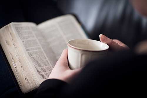 reading the bible with a cup of coffee